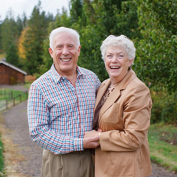 An older couple Graham T. Egger DDS patients smiling after their restorative treatment